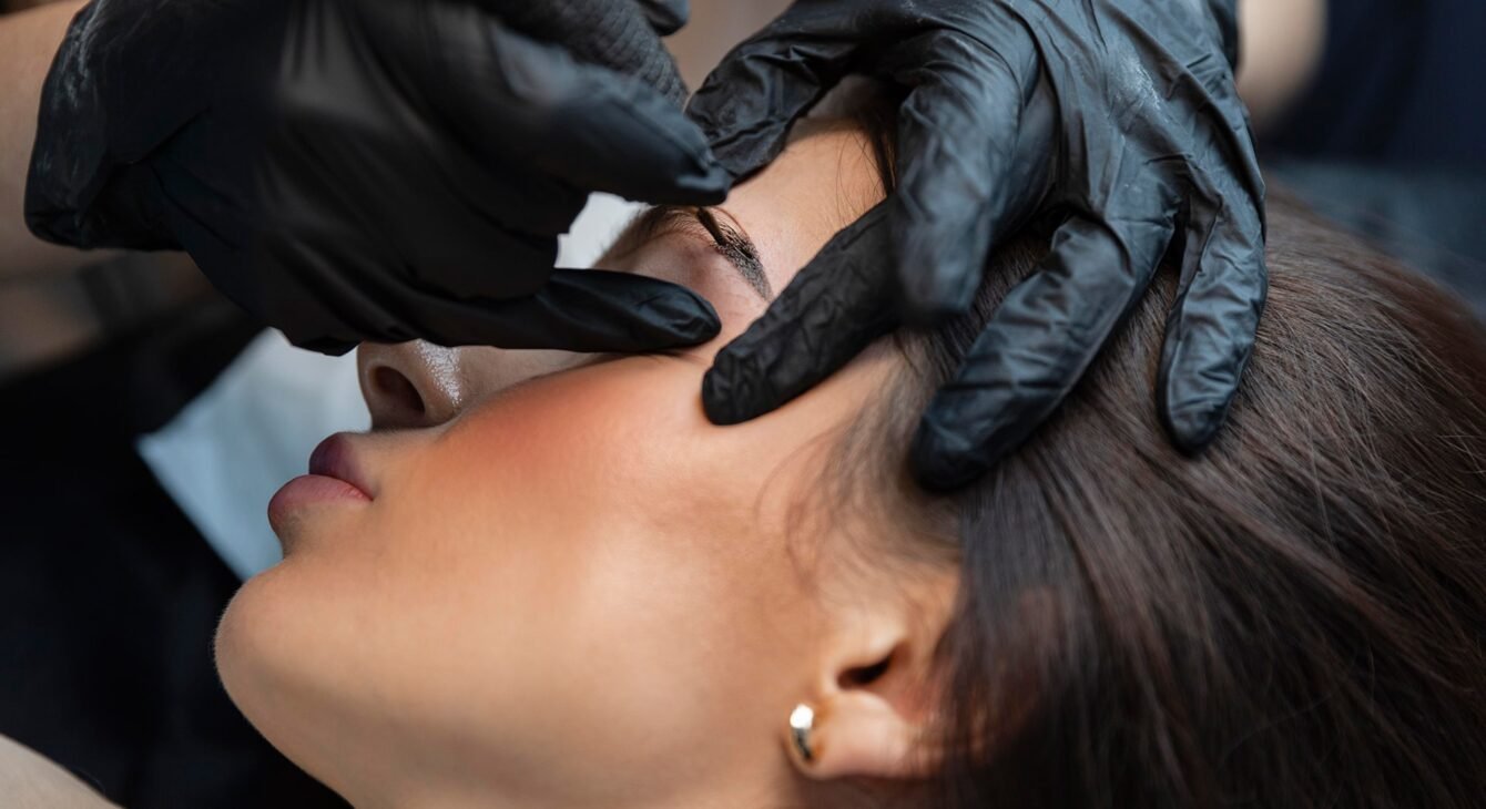 young-woman-getting-beauty-treatment-her-eyebrows young-woman-getting-beauty-treatment-her-eyebrows